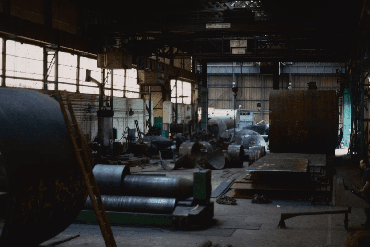 Production bay with compression presses and stock material